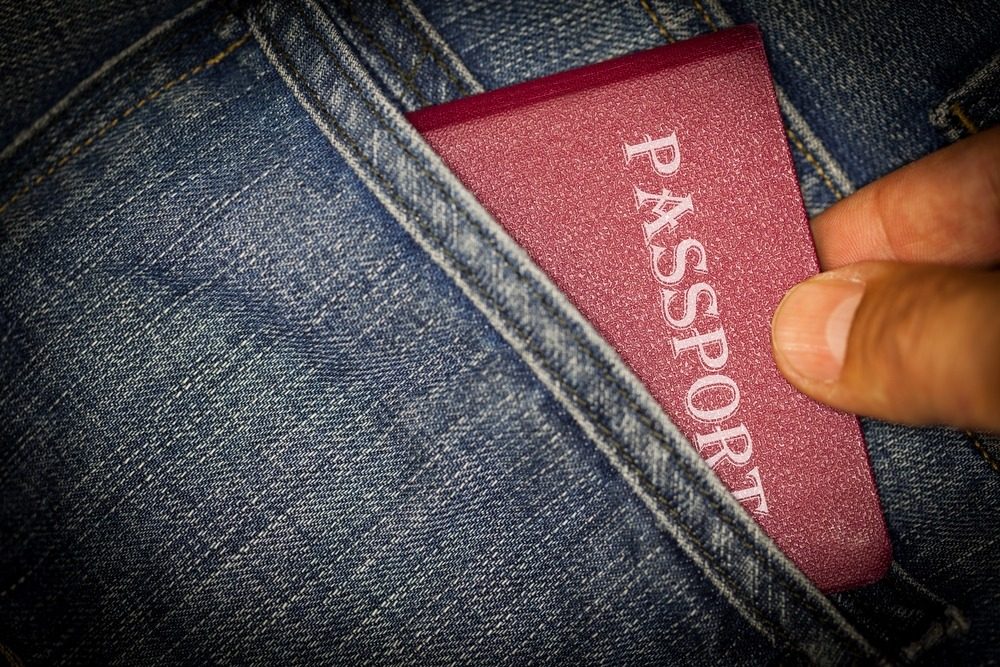 a traveller's passport in the pocket of their jeans