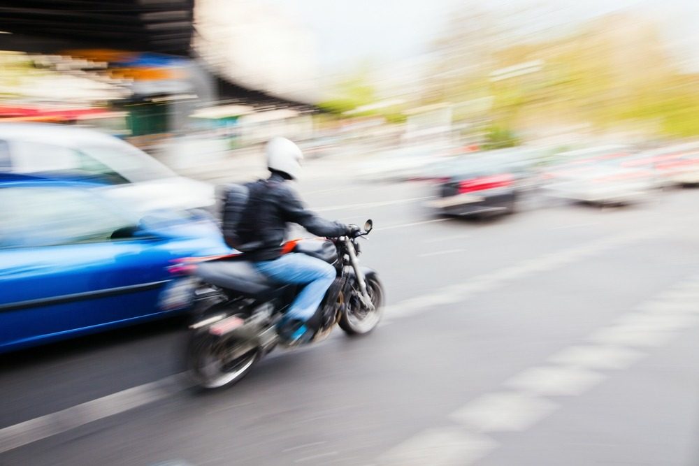 motorcyclist overtaking a car on the right