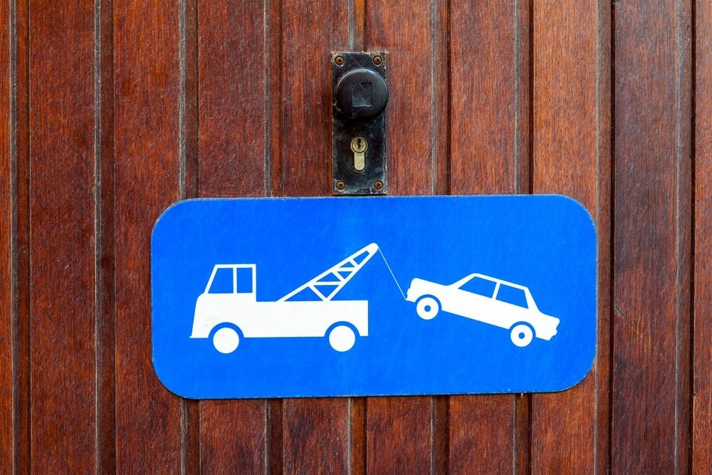 Pictogram showing a tow truck removing a badly parked vehicle