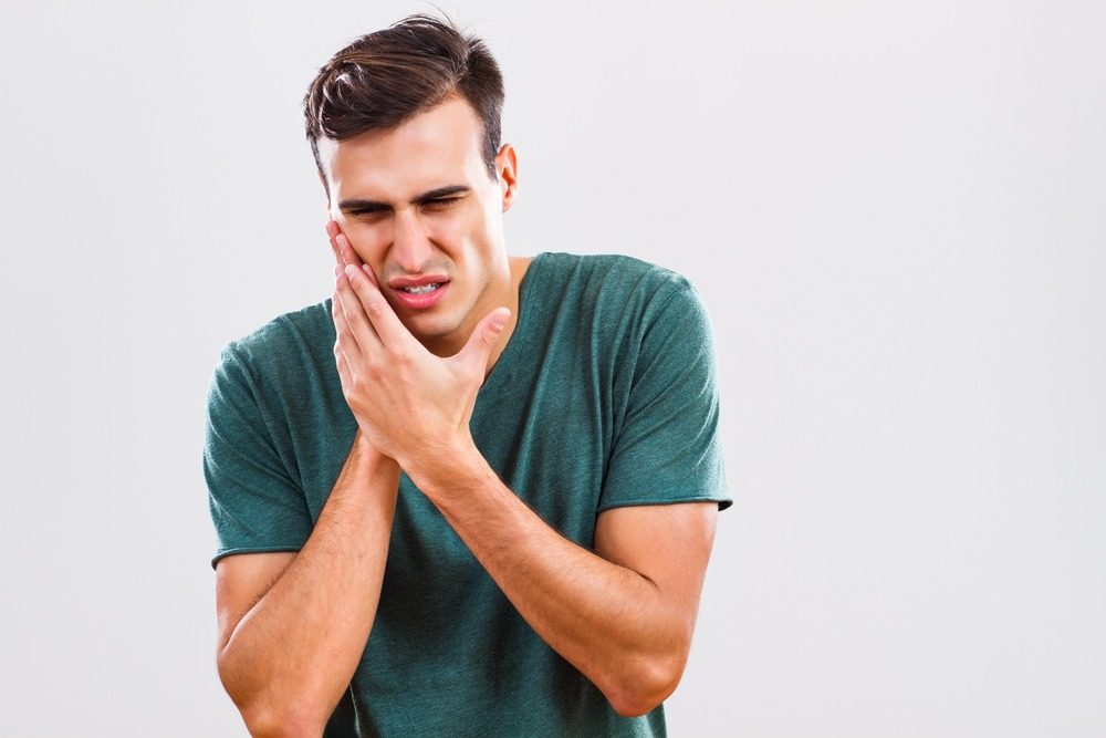Person suffering from toothache during their trip