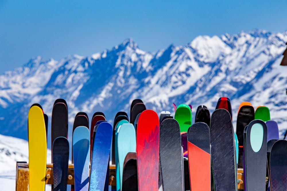 Ski rack with several skis - snowy mountain landscape