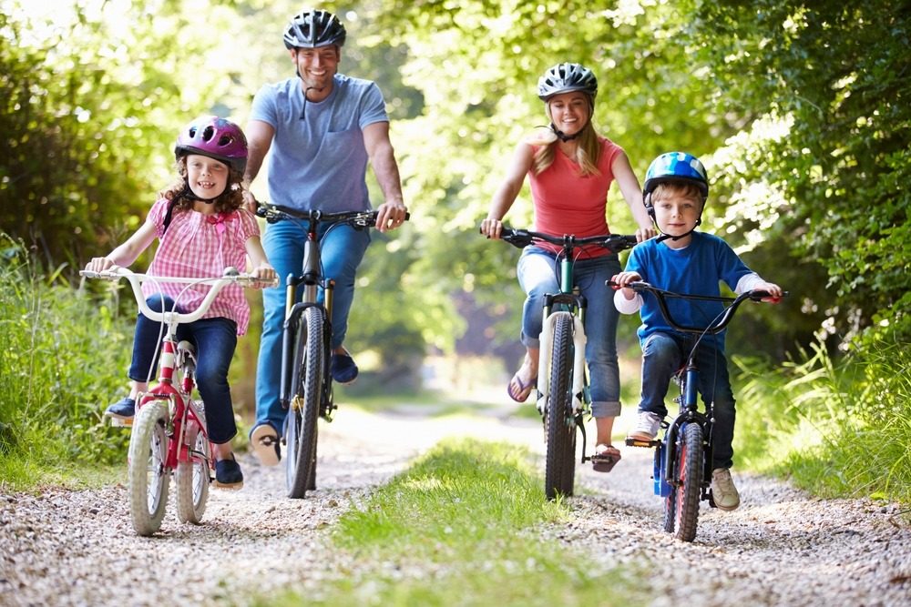 Family taking a bike ride in a shaded spot