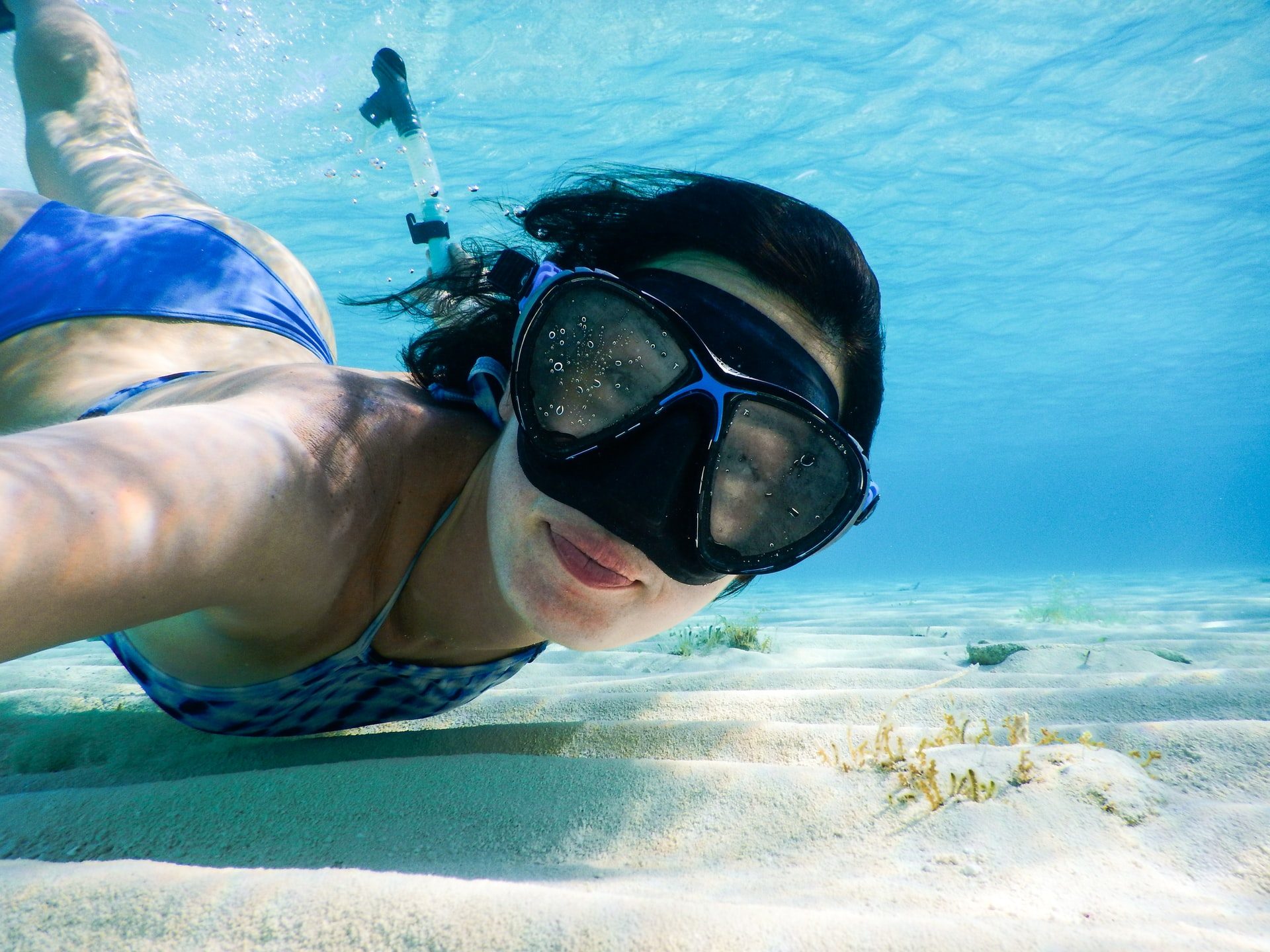 Young woman diving with a mask in the Mediterranean