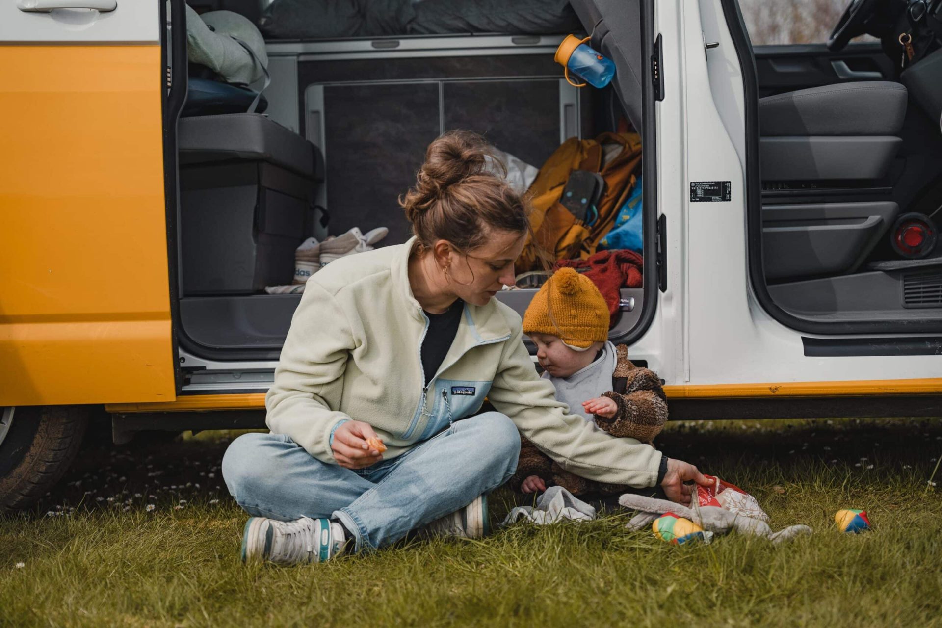 Mum and young child in front of the car on their road trip