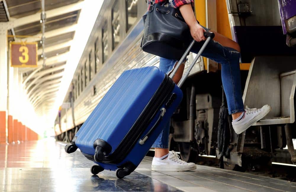 Person boarding a train with luggage