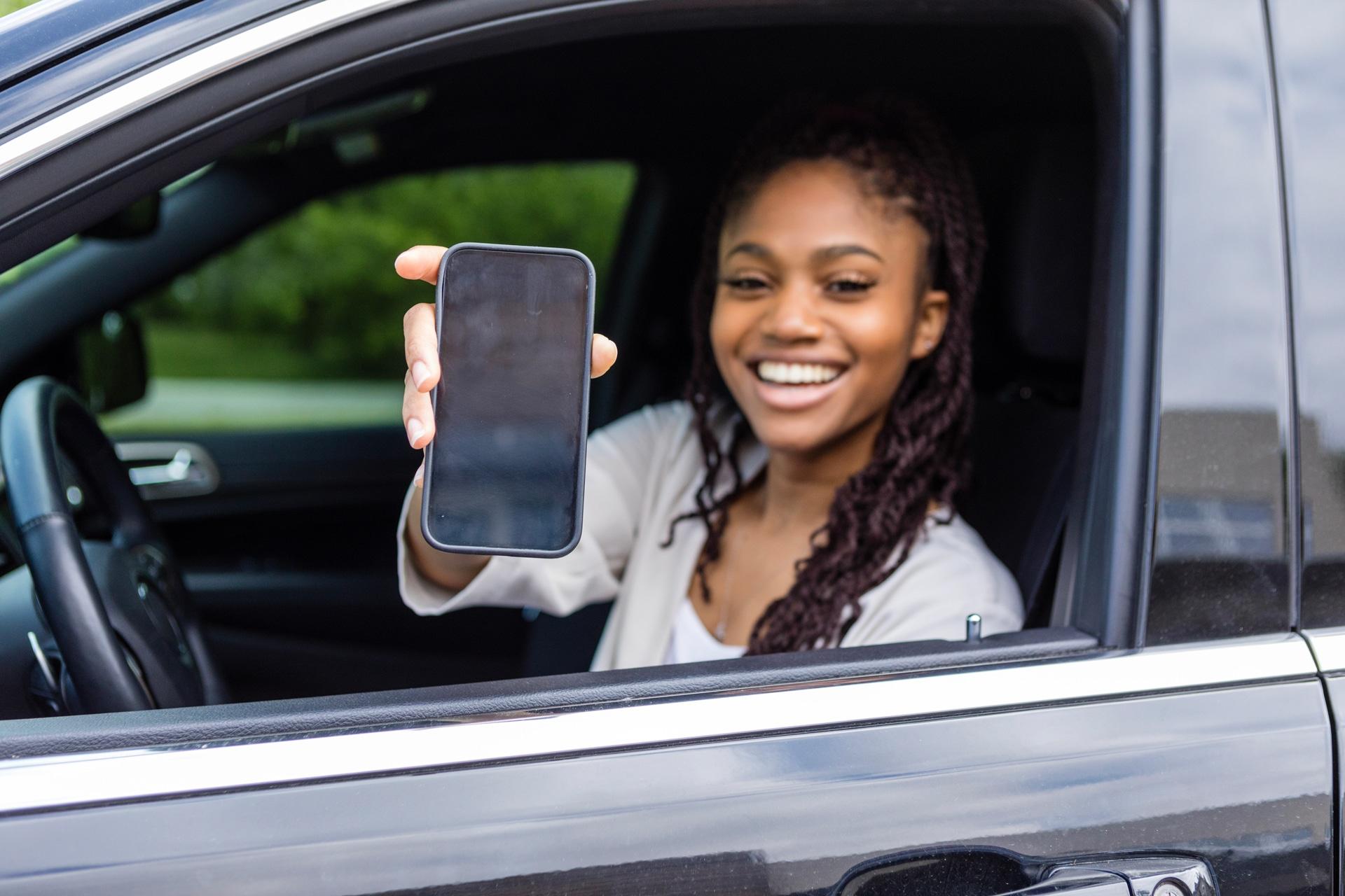 Bestuurder van auto toont digitaal rijbewijs op haar smartphone