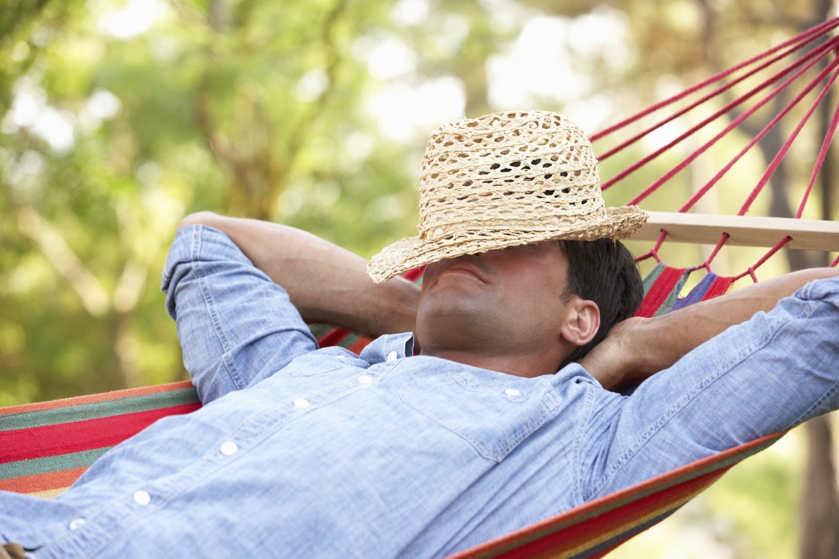 Man relaxing in a hammock during extreme heat.
